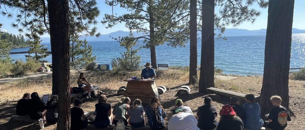 A group of campers gathered at the outdoor chapel during reflection at Camp Galilee.