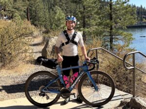 Galilee Food Services Director Chadwick Clark standing next to his road bike at Galilee.